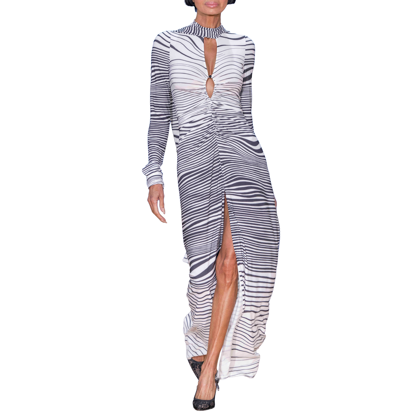 Woman wearing a black and white striped dress with a high slit on a white background